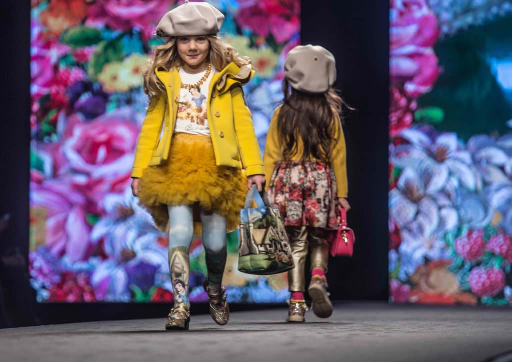 Toddlers with Snow White and the Seven Dwarves prints at the Monnalisa kids catwalk show in Florence at Pitti Bimbo 84