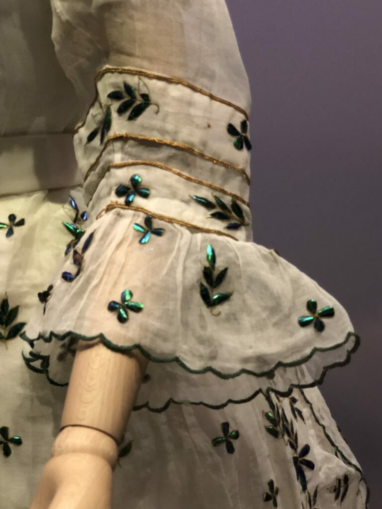 Over 5000 beetle wings and parts of wings were used to decorate this dress from 1868. India imported beetle wing cases and in one instance in 1867 sold 25,000 in one consignment - from Fashioned by Nature at the V&A Museum now