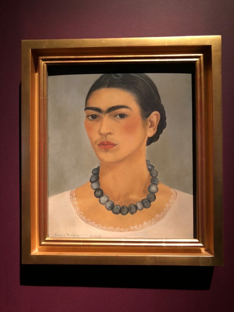 Self portrait iconic of Frida Kahlo from 1933 when she and Diego riviera were living in the US shows her unconventional appearance for the time.