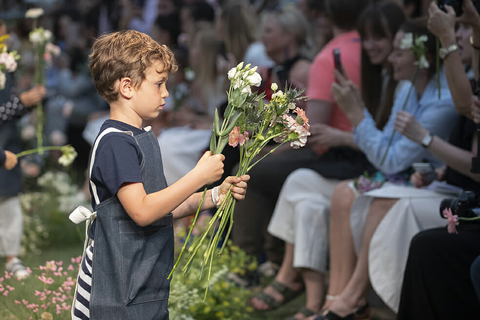 For the catwalk show's finale, apron wrapped mini models handed the audience floral bouquets to take home at Il Gufo Pitti Bimbo 89