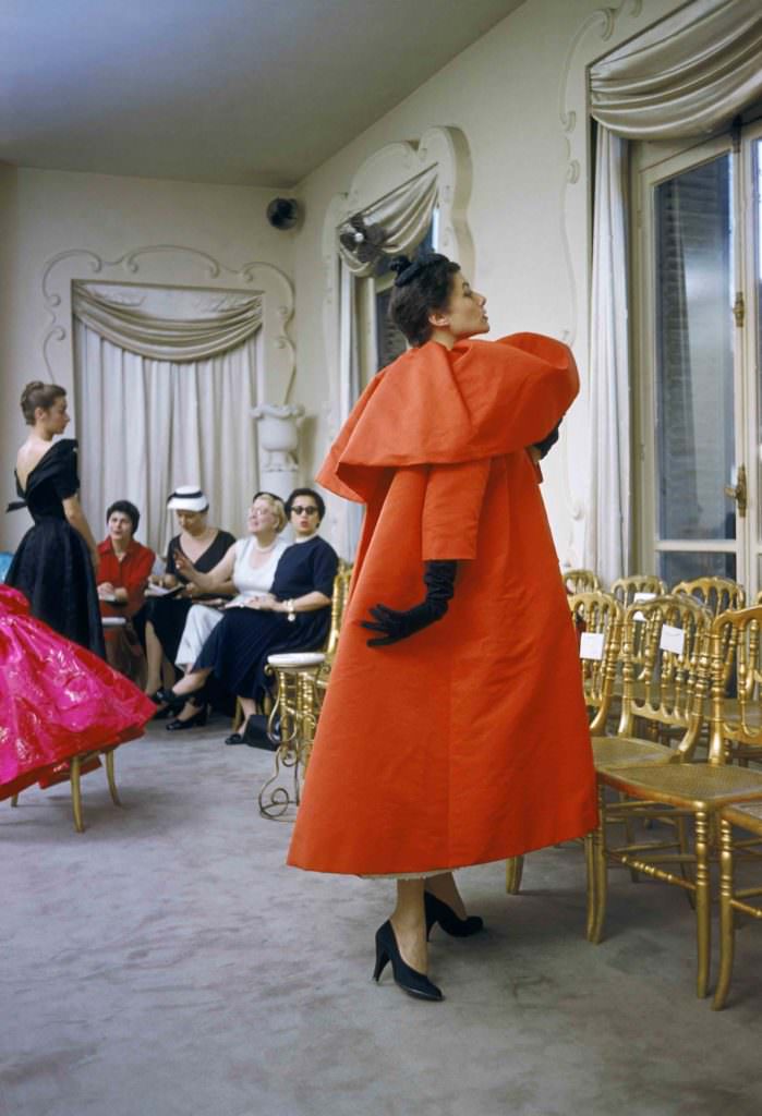 Model wearing Balenciaga-coat as I. Magnin buyers inspect a dinner outfit in the background,Paris 1954-by Mark Shaw / mptvimages.com