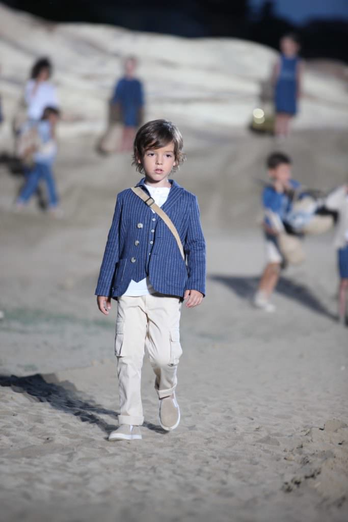 Simple boys tailoring at Il Gufo with models climbing the sand dunes behind in their Florence fashion show for spring 2018