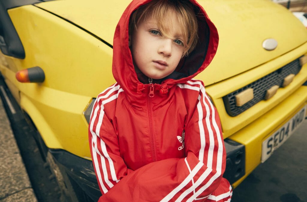 Kyd wears windbreaker jacket by Adidas for East End boys photoshoot by Damian Weilers