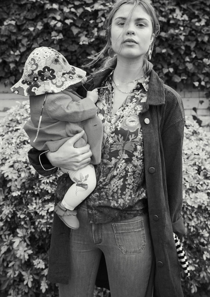 Jordan wears corduroy jacket by Polder, floral shirt by Roseanna, bracelet & necklaces by Titlee, earrings by Imaœ, Jeans by Bonton Maxi Me. Baby Daisy wears jacket by Bonton, floral hat by Chloe, Printed leggings by Catamini, Shoes by Amy & Ivor