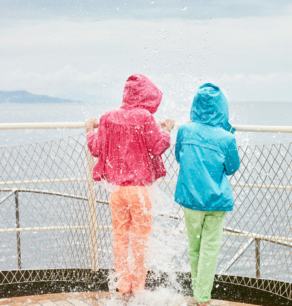 Bright coral colours for rainy day gear at Il Gufo kids fashion for spring 2019